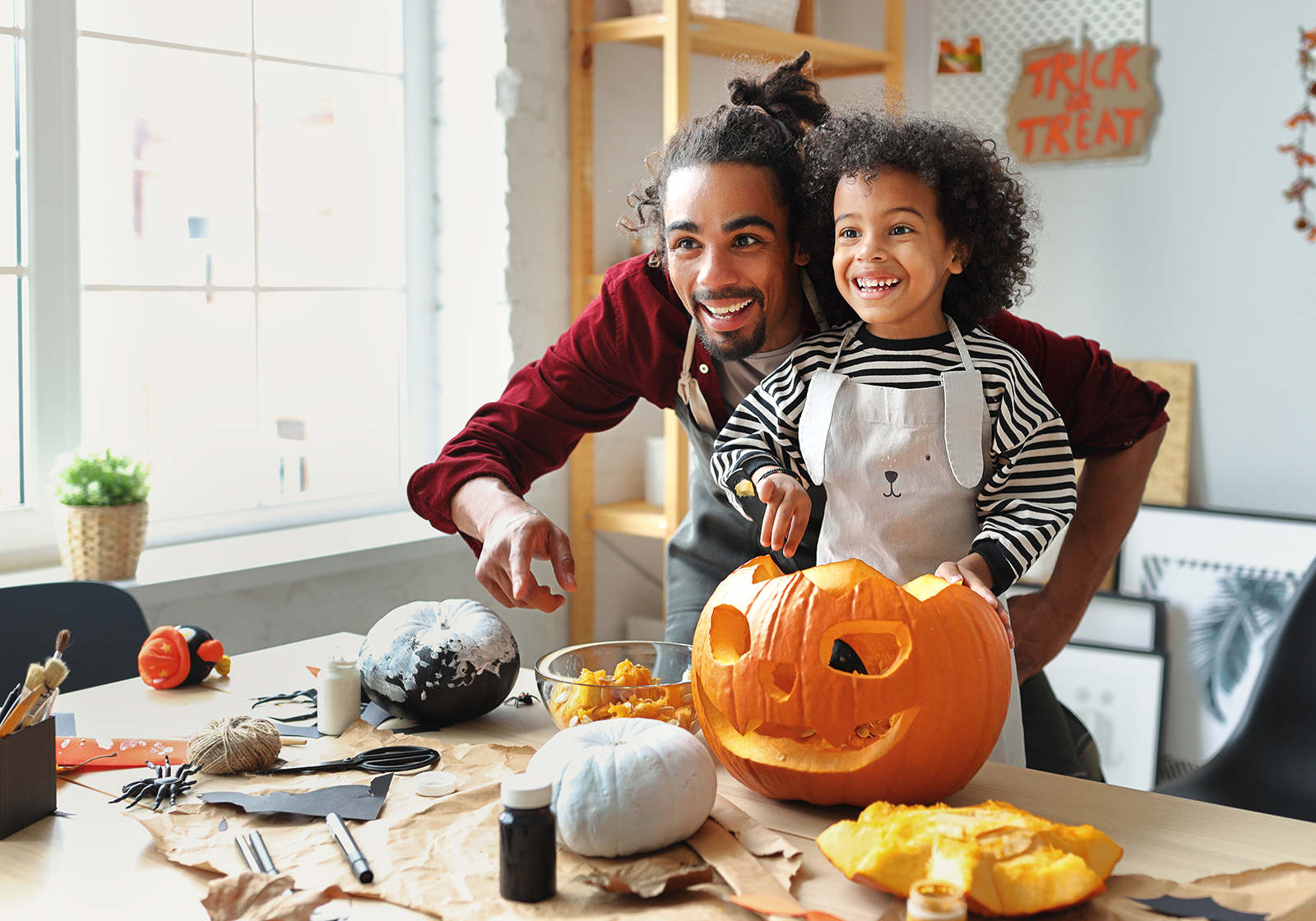 Father and child carving a pumpkin