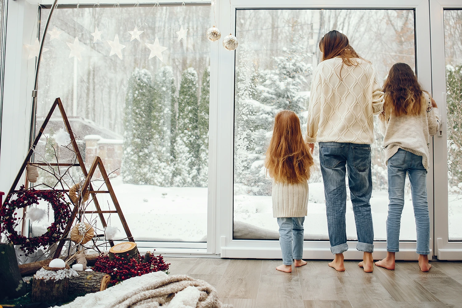 Family looking out at snow-covered yard