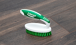 Scrub brush on kitchen floor