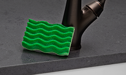 Green sponge on kitchen countertop