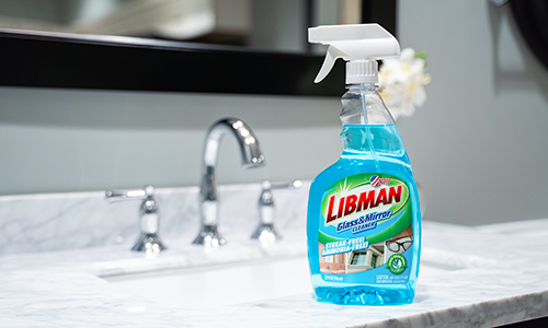 Bottle of glass cleaning solution on a bathroom countertop