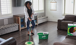 Woman cleans her floor with the Tornado Spin Mop System