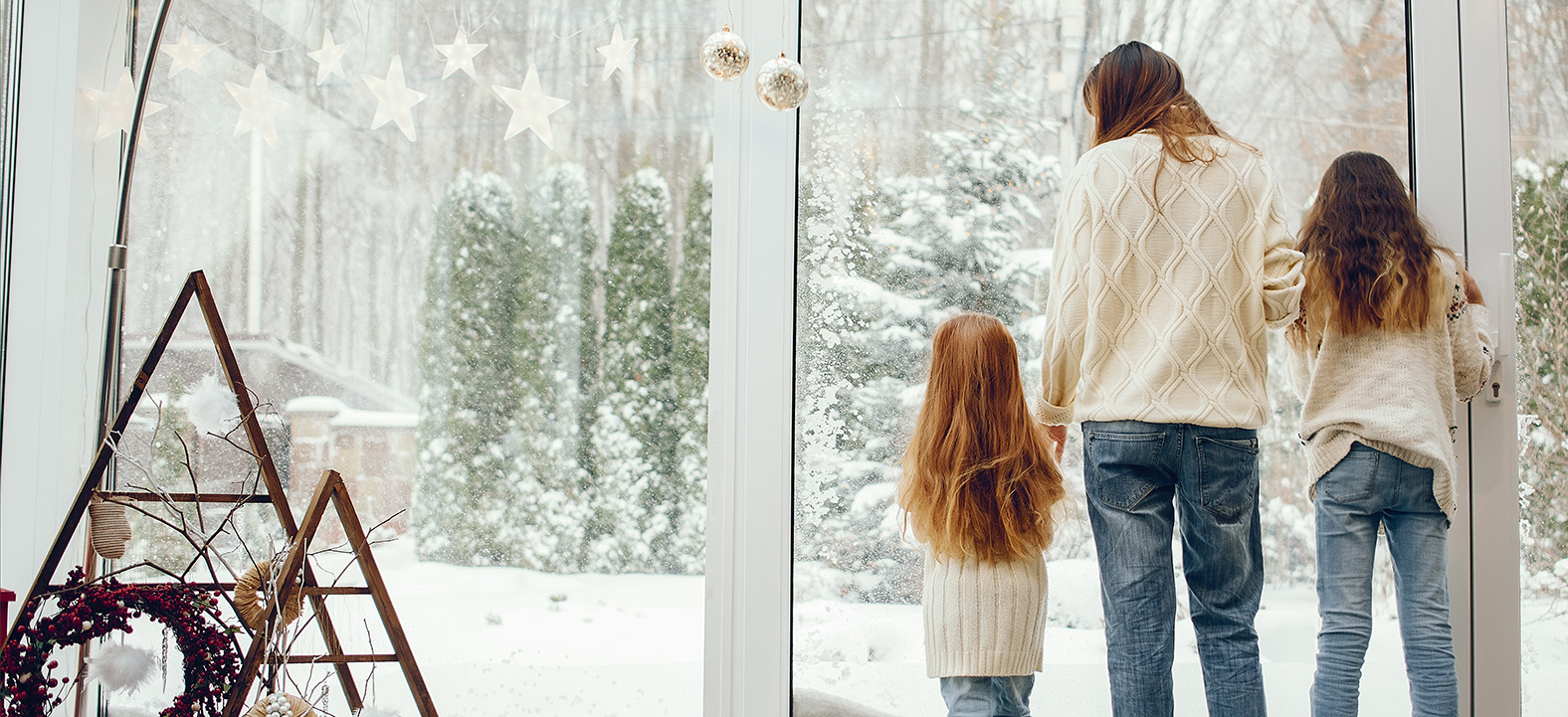 Family looking out at snow-covered yard