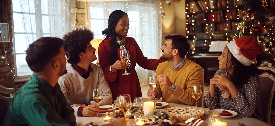 Group of friends having a meal together in a festively decorated home