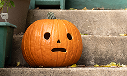 Pumpkin with a face on a porch