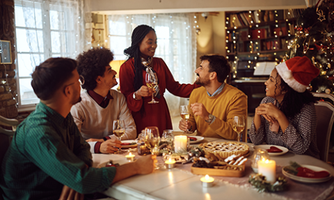 Group of friends having a meal together in a festively decorated home