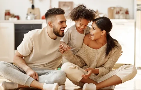Family of three in their living room